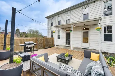 a patio with a couch and a table on a deck at Pet and Family Friendly! Home with Fenced Yard and Deck in York Haven