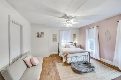 a bedroom with a bed and a couch at Pet and Family Friendly! Home with Fenced Yard and Deck in York Haven