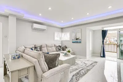 a living room with a couch and a table at Waterfront Lake Hopatcong Home with Boat Dock! in Mount Arlington
