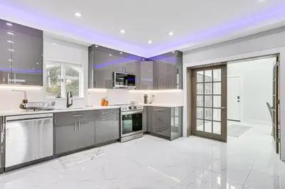 a kitchen with stainless steel appliances and a large window at Waterfront Lake Hopatcong Home with Boat Dock! in Mount Arlington
