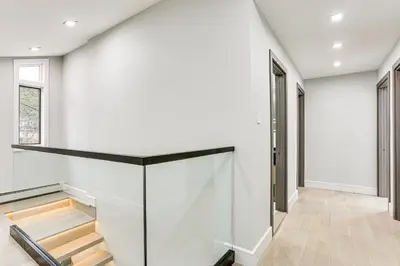 a staircase in a house with a glass wall at Waterfront Lake Hopatcong Home with Boat Dock! in Mount Arlington