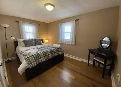 a bedroom with a bed and a mirror and a table at Hideaway - LakeHouse/spa/dock/ in Pocono Summit