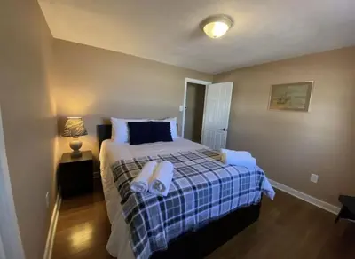 a bedroom with a bed with towels on it at Hideaway - LakeHouse/spa/dock/ in Pocono Summit