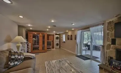 a living room with a couch and a fireplace at Hideaway - LakeHouse/spa/dock/ in Pocono Summit