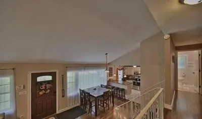 a dining room and kitchen with a table and chairs at Hideaway - LakeHouse/spa/dock/ in Pocono Summit