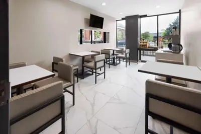 a dining room with tables and chairs in a restaurant at Days Inn by Wyndham Staten Island in Staten Island