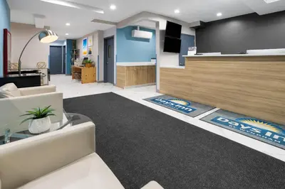 a living room with a couch and a table at Days Inn by Wyndham Staten Island in Staten Island