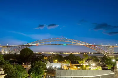 a bridge over a city at night at Days Inn by Wyndham Staten Island in Staten Island