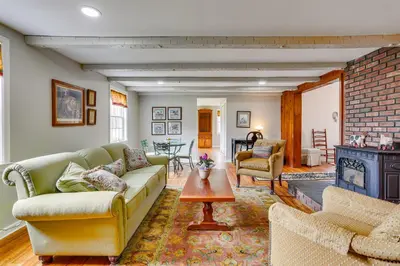a living room with a couch and a fireplace at Historic Farmhouse in Layton with Deck! in Layton