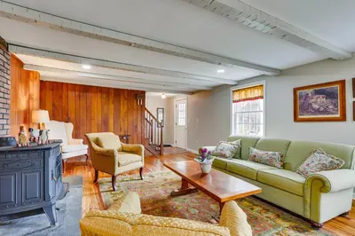 a living room with a couch and a table at Historic Farmhouse in Layton with Deck! in Layton