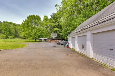 a parking lot next to a building with a basketball hoop at Historic Farmhouse in Layton with Deck! in Layton