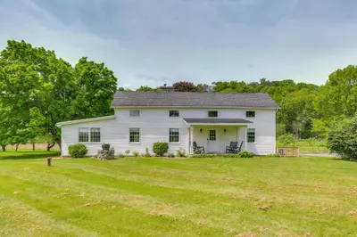 a white farm house with a large yard at Historic Farmhouse in Layton with Deck! in Layton