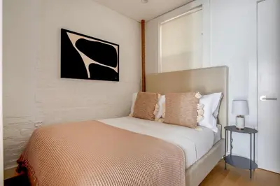 a bedroom with a bed and a picture on the wall at Classic LES 1br w wd nr SoHo NYC-646 in New York