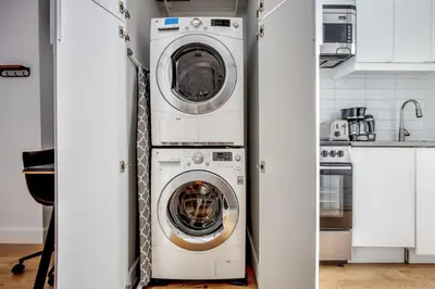 a washer and dryer in a white kitchen at Classic LES 1br w wd nr SoHo NYC-646 in New York