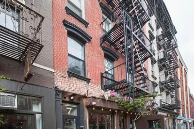 a fire escape on the side of a brick building at Classic LES 1br w wd nr SoHo NYC-646 in New York