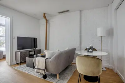 a living room with a couch and a table at Classic LES 1br w wd nr SoHo NYC-646 in New York