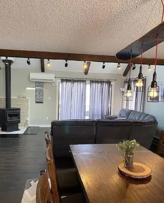 a living room with a couch and a table at Stylish Townhouse Steps to Ski Mtn & Waterpark in Tannersville