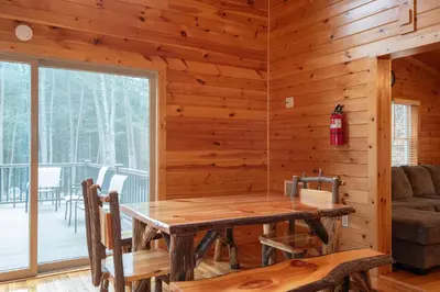 a dining room with a table in a cabin at Fisher Mountain Retreat in Woodward