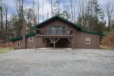 a large house with a balcony on a lot at Fisher Mountain Retreat in Woodward