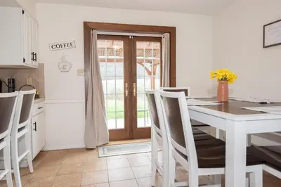 a kitchen and dining room with a table and chairs at Scenic View Lodging in Millerstown