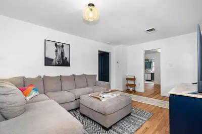 a living room with a couch and a table at White Clay Creek Cottage in Newark