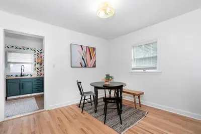 a dining room with a table and a kitchen at White Clay Creek Cottage in Newark
