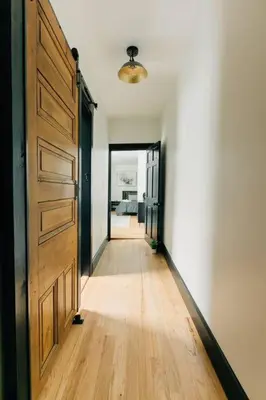 a hallway with a large wooden door and a bedroom at Stunning 5 BR -Heart of Downtown in Lancaster