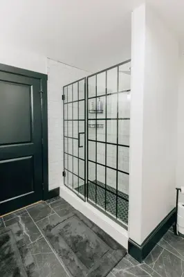 a bathroom with a black door and a window at Stunning 5 BR -Heart of Downtown in Lancaster