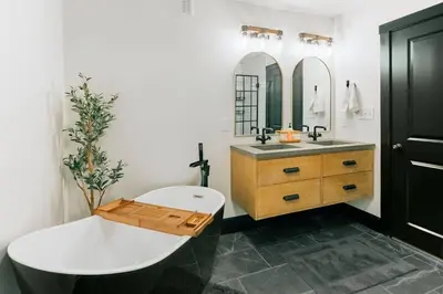 a bathroom with a white tub and a sink at Stunning 5 BR -Heart of Downtown in Lancaster