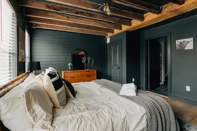 a bedroom with a large bed and a blue wall at Stunning 5 BR -Heart of Downtown in Lancaster