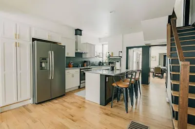 a kitchen with white cabinets and a green refrigerator at Stunning 5 BR -Heart of Downtown in Lancaster