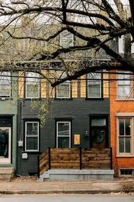 a black house with a fence in front of it at Stunning 5 BR -Heart of Downtown in Lancaster