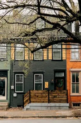 a black house with a fence in front of it at Stunning 5 BR -Heart of Downtown in Lancaster