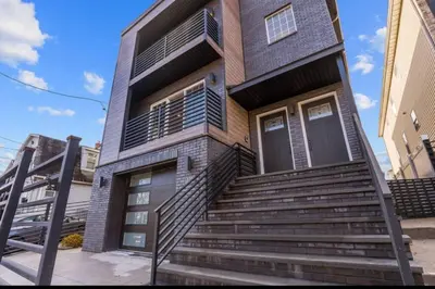 a brick house with stairs in front of it at Dream! in Newark