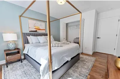 a bedroom with a large canopy bed with a rug at Dream! in Newark
