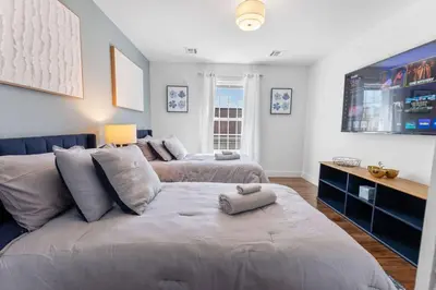 a bedroom with two beds and a couch at Cityscape in Newark