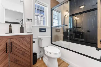 a bathroom with a toilet and a shower and a sink at Cityscape in Newark