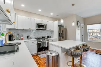 a kitchen with white cabinets and a white counter top at Luxe Newark Retreat with Rooftop Deck Pets Welcome! in Newark
