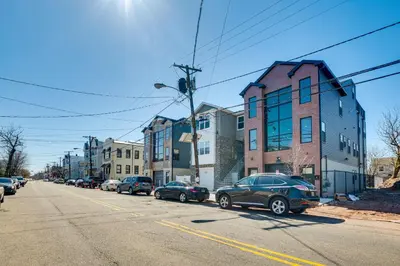 a street with cars parked on the side of the road at Luxe Newark Retreat with Rooftop Deck Pets Welcome! in Newark