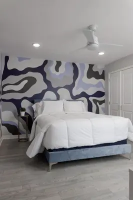 a bedroom with a large bed with a camouflage wall at Comfortable living in Philadelphia