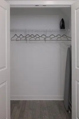 a kitchen with white walls and a white shelf at Comfortable living in Philadelphia