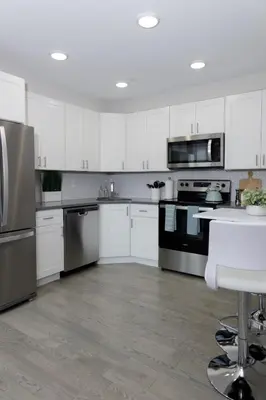a kitchen with white cabinets and stainless steel appliances at Comfortable living in Philadelphia