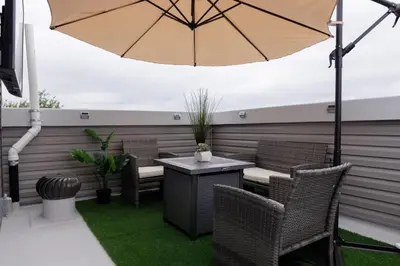a patio with a table and chairs and an umbrella at Comfortable living in Philadelphia