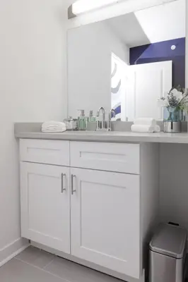 a bathroom with white cabinets and a sink at Comfortable living in Philadelphia