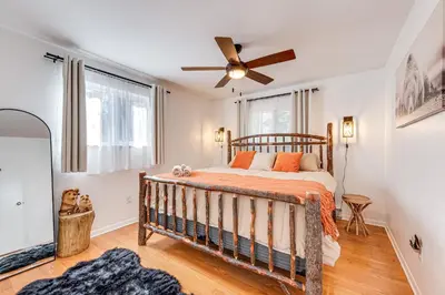 a bedroom with a bed and a ceiling fan at Game Room and Fire Pit Chic Pocono Pines Home! in Pocono Pines