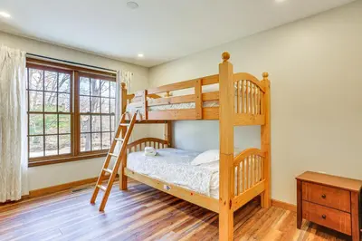 a bedroom with two bunk beds and a ladder at Forest-View Deck and Fire Pit Poconos Escape! in East Stroudsburg