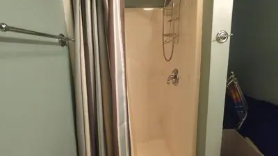 a shower in a bathroom with a shower curtain at The Bear Foot Lodge by AvantStay Game Room Deck BeachLake Access in Albrightsville