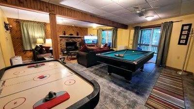a living room with a pool table and a living room at The Bear Foot Lodge by AvantStay Game Room Deck BeachLake Access in Albrightsville