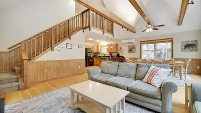 a living room with a couch and a table at Woodland Oasis by AvantStay Hot Tub Firepit Walk to Lake in Lake Harmony