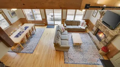 an overhead view of a living room with a couch and a fireplace at Woodland Oasis by AvantStay Hot Tub Firepit Walk to Lake in Lake Harmony